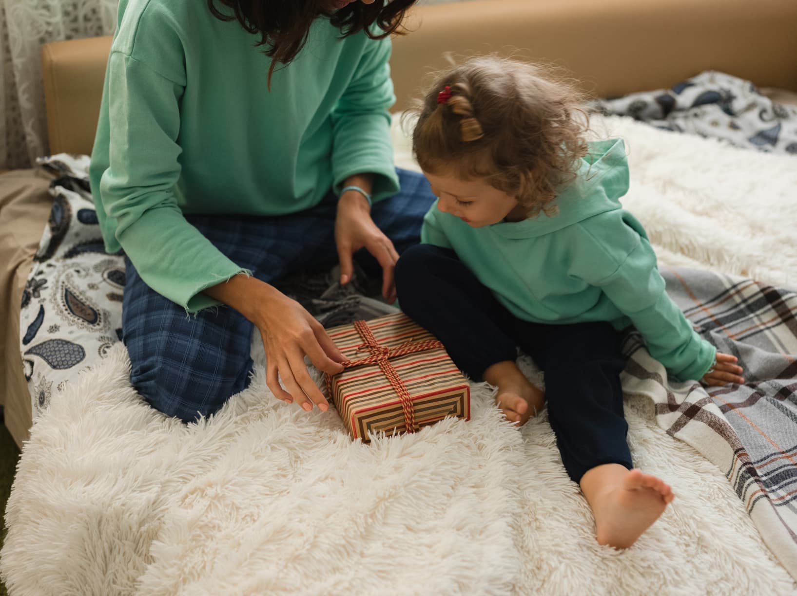 Parent and toddler with a wrapped gift